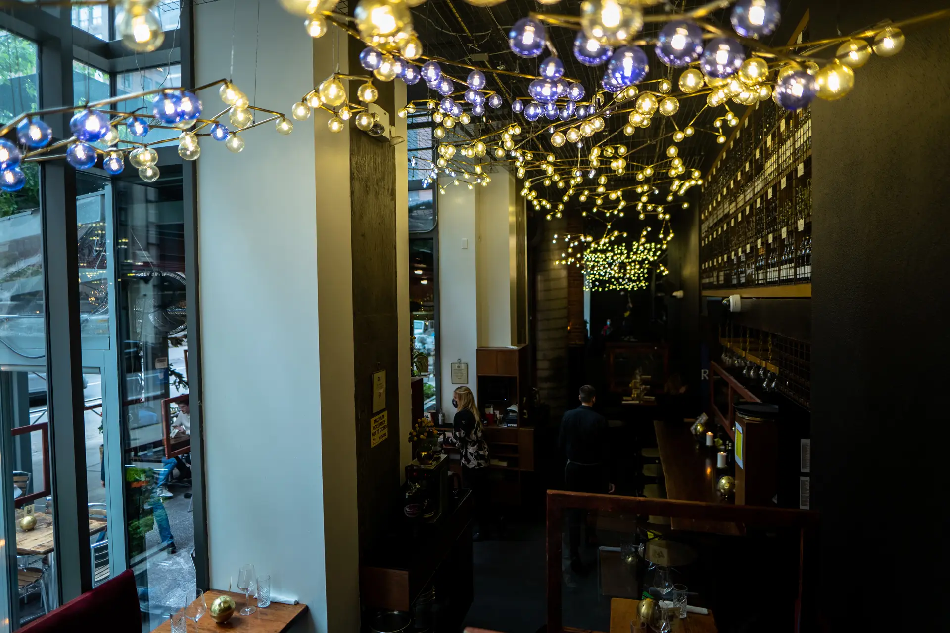 Cozy dining area at Ayza Restaurant with handmade iridescent yellow light fixtures