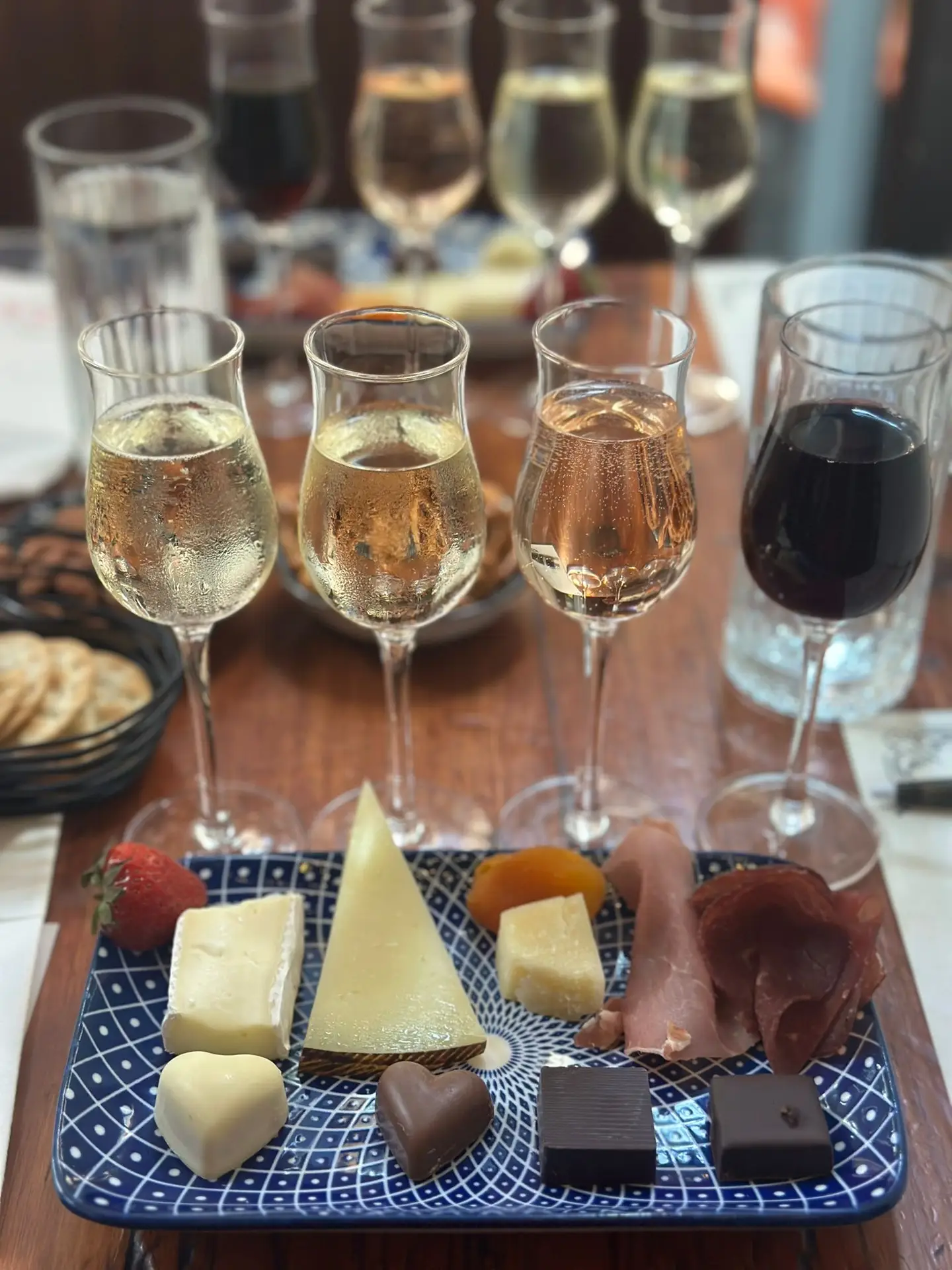Image showcases a premium tasting table with wine, cheese, and chocolate pairings arranged for an executive retreat. Elegant glassware and brand menus add to the refined ambiance.
ALT: AYZA’s complete wine, cheese, and chocolate tasting experience for executive retreats.