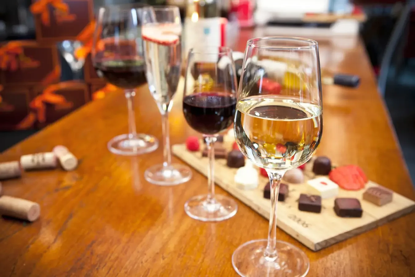 Ayza Wine Bar Restaurant table with glasses of red and white wine, chocolate treats, and elegant dining atmosphere. Perfect spot for chocolate and wine lovers.